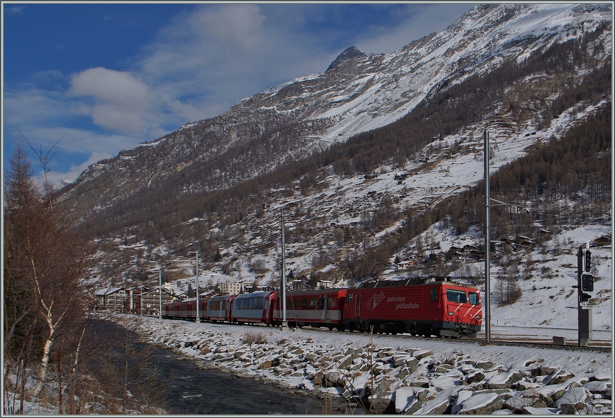 Bei überraschend wenig Schnee fährt eine MGB HGe 4/4 mit ihrem Reisezug kurz nach Täsch Zermatt zu. 
28. Jan. 2015