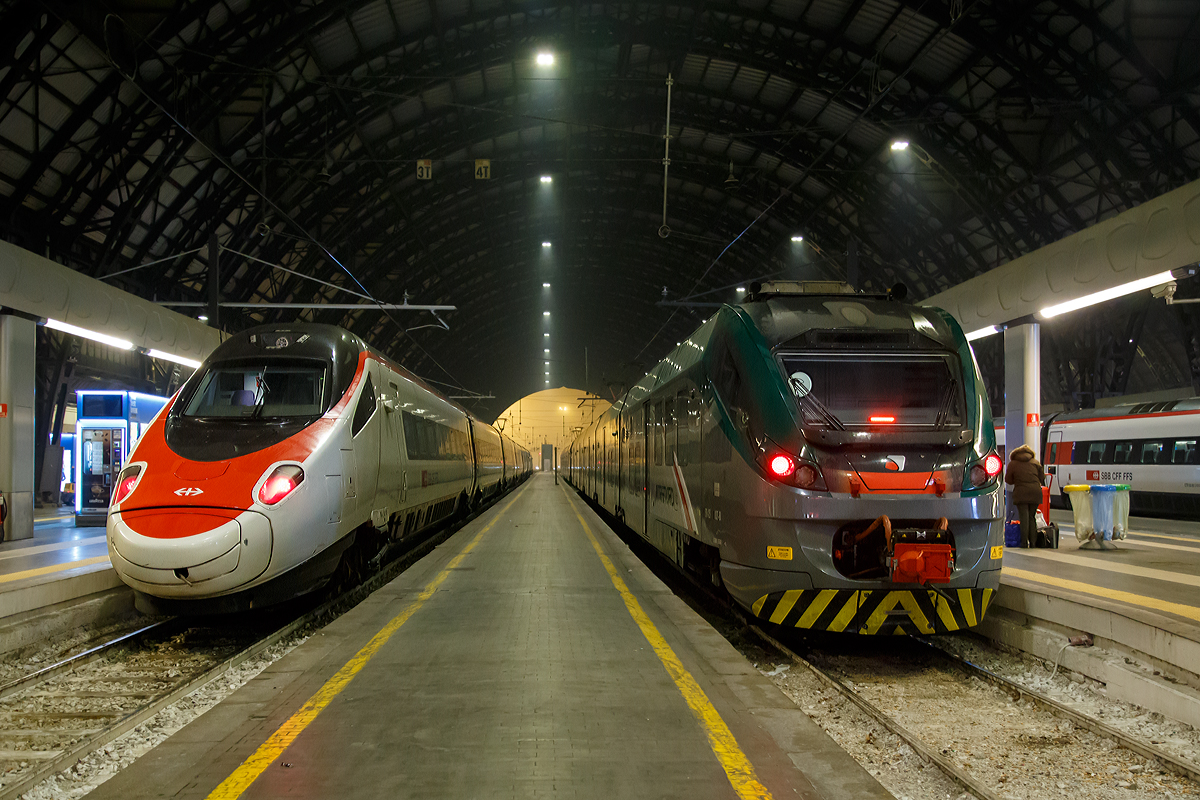 
Der SBB ETR 610 der 2. Serie  (RABe 503 014) hat als EC 39 (Basel SBB - Milano Centrale) am 27.12.2015 den Milano Centrale (Mailand Zentral) erreicht und uns die letzte Etappe gut ans Zeil gebracht. 

Rechts auf dem anderen Gleis stehen zwei gekuppelte ETR 425 der Trenord (ETR 425 037 und ein weiterer) zur Ausfahrt bereit.