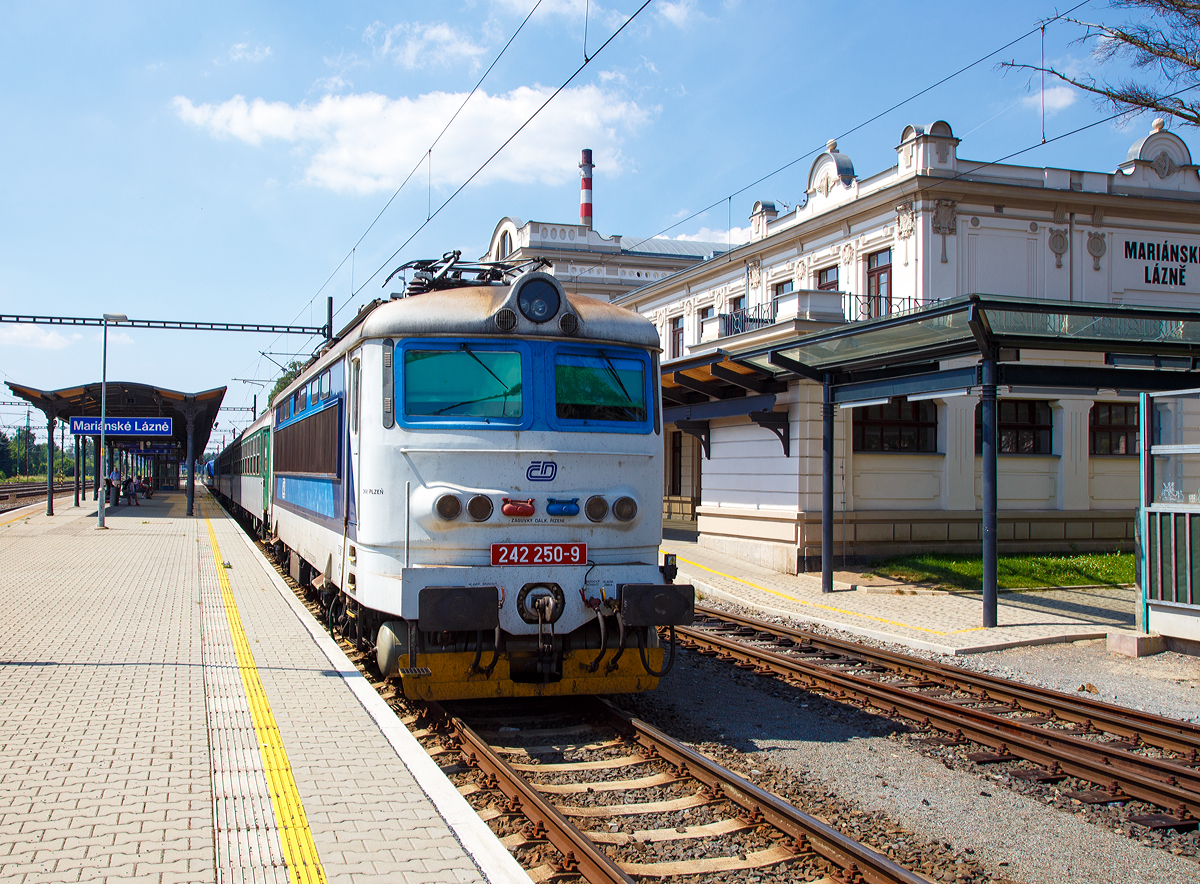Die 242 250-9 (CZ - ČD 91 54 7 242 250-9), eine reine Wechselstrom E-Lok der tschechischen Česk� dr�hy (ČD), steht am 01.07.2015 mit einem Personenzug im Bahnhof Mari�nsk� L�zně (Marienbad).

Die ČD Baureihe 242 (�koda 73E), ehemals ČSD-Baureihe S 499.02 bzw. ab 1988 Baureihe 242, ist eine elektrische Lokomotive der einstigen Tschechoslowakischen Staatsbahn ČSD f�r das mit 25 kV 50 Hz Wechselstrom elektrifizierte Streckennetz im S�den und Westen der ehemaligen Tschechoslowakei. Sie wurden aus der ČSD S 499.0 entwickelt, von der sie sich vor allem durch einen anderen Lokkasten unterscheidet. W�hrend die S 499.0 einen Lok-Kasten aus glasfaserverst�rktem Kunststoff haben, wurde bei der �koda 73E (S 499.02) der herk�mmlich gefertigte Lokomotivkasten, wie er auch f�r die Gleichstromlokomotiven verwendet wurde, angewandt. Lediglich das f�r die K�hlung des Transformators und die Hochspannungssteuerung n�tige L�fterband wurde anstelle der gro�en Seitenfenster verwendet. Als weitere �nderung haben die Lokomotiven einen Hilfsfahrschalter und eine Einrichtung zur Reduzierung der Achsentlastung bei Zuganfahrten und Fahrten auf Steigungsstrecken. Daf�r erhielten die Lokomotiven spezielle Deichselstangen zwischen den Drehgestellen und eine spezielle Steuerung des Stromrichters. Wie bei der S 499.0 wurde die Lokomotive mit 32 Fahrstufen gesteuert. Lokomotiven dieses Typs wurden auch an die Bulgarische Staatsbahn BD� geliefert.

Von den Lokomotiven der Reihe S 499.02 wurden insgesamt 86 Maschinen bei der ČSD in Dienst gestellt. Mit der am 30. November 1981 ausgelieferten S 499.0286 endete bei �koda die Fertigung der elektrischen Lokomotiven der sogenannten Ersten Generation. Die Lokomotiven sind sowohl vor G�terz�gen als auch vor Schnellz�gen anzutreffen. 1988 wurden die Lokomotiven in die Baureihe 242 umgezeichnet. S�mtliche Lokomotiven gelangten nach 1993 zu den Tschechischen Bahnen ČD und sind dort noch im Einsatz.

TECHNISCHE DATEN:
Herstellertyp: �koda 73E
Baujahre: 1975–1981
Spurweite: 1.435 mm (Normalspur)
Achsformel:  Bo'Bo'
L�nge �ber Puffer: 16.440 mm
Drehzapfenabstand: 7.800 mm
Achsabstand im Drehgestell: 2.800 mm
Dienstgewicht:  86,0 t
Radsatzfahrmasse:  21,5 t
H�chstgeschwindigkeit:  120 km/h
Stundenleistung:  3.200 kW
Dauerleistung:  3.080 kW
Anfahrzugkraft: 240 kN
Stromsystem:  25 kV 50 Hz Wechselstrom
Anzahl der Fahrmotoren:  4
Antrieb: �koda Hohlwellenantrieb
