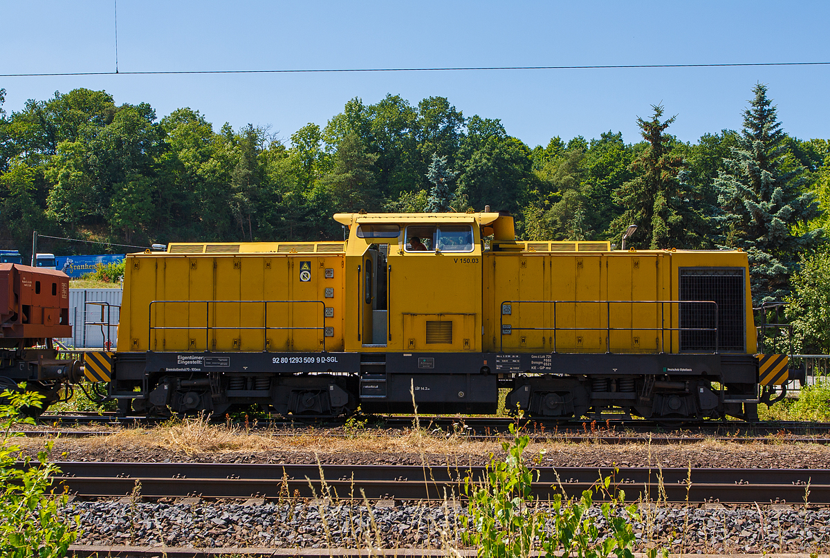 Die V 150.03 (293 509-6), der SGL Schienen-Güter-Logistik GmbH, ex DR 110 963-6, ex DR 710 963-0, ex DB 710 963-0 (eine ehem. DR V 100.5) mit Zweiseitenkippwagen Typ Fas (diese wurden gerade mit Kies beladen) am 20.07.2013 beim Bahnhof Sinn (Lahn-Dill-Kreis) an der KBS 445 (Dillstrecke).

Die (Spender) Lok wurde 1983 von LEW (VEB Lokomotivbau Elektrotechnische Werke „Hans Beimler“ ,Hennigsdorf) unter der Fabriknummer 17312 gebaut und als DR 110 963-6 in Dienst gestellt, 1992 Umzeichnung in 710 963-0 und 1996 die Ausmusterung bei der DB. Bis 1999 war sie bei der DGT (Deutsche Gleis- und Tiefbau GmbH, Berlin) als 710 963-0 im Einsatz. 1999 erfolgte der Umbau bei Regental Fahrzeugwerkstätten GmbH gemäß Umbaukonzept BR 293 der ABB Daimler Benz Transportation GmbH. Im Jahr 2000 kam sie dann zur GSG Knape Gleissanierung GmbH, Kirchheim (Muttergesellschaft der SGL) als V 150.03 und 2008 zur SGL Schienen Güter Logistik GmbH, Dachau als V 150.03  (NVR-Nummer: 92 80 1293 509-6 D-SGL).

Zur Baureihe 293:
ABB Daimler Benz Transportation (ADtranz) hat zwischen 1995 und 2002 insgesamt 59 ehem. DR V 100 Loks umfassend modernisiert. Sie erhielten die neue Baureihenbezeichnung BR 293. Die Modernisierung umfaßt u.a. die Aufarbeitung von Lokrahmen, Vorbauten, Führerhaus und Strömungsgetriebe. Der alte KVD Motor (Hersteller: VEB Kühlautomat Berlin-Johannistal) wird gegen einen Caterpillar oder MTU Motor getauscht, die Druckluftanlage wird erneuert, ebenso die elektrische Steuerung. Neu ist eine hydraulisch angetriebene Kühlanlage. Optional ist auch eine Funkfernsteuerung möglich. Von den 59 modernisierten Loks wurden für 21 Loks neue Betriebsbücher angelegt, da sich die Herkunft der Loks nicht klären läßt. Deshalb erhielten diese Loks eine neue Fabriknummer.

Technische Daten:

Achsanordnung: B'B'
Spurweite: 1.435 mm
Länge über Puffer: 14.240 mm
Breite: 3.140 mm
Drehzapfenabstand: 7.000 mm
Gesamtachsstand: 9.300 mm
Höchstgeschwindigkeit 100 km/h
Motor: 12-Zylinder-4-takt-Dieselmotor mit Turbolader und Ladeluftkühlung CAT 3512 DI-TA
Motoren Hersteller: Zeppelin Baumaschinen GmbH Achim (b.Bremen)
Hubraum 51,8 Liter ( 170 mm Bohrung / 190 mm Hub)
Gewicht des Motors: 6.537 kg
Leistung: 1050 kW / 1428 PS bei 1800 U/min

Quellen: V 100-online.de / Zeppelin Baumaschinen