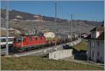 Die SBB Re 4/4 II 11285 (Re 420 285-9) ist mit einem Güterzug in Cully unterwegs und passt einigermassen zwischen die Fahrleitungsmasten. 

20. Februar 2023