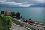 Eine SBB Re 460 mit ihrem IR von Brig nach Genève Aéroport erreicht bei spannendem Wetter die Haltestelle Rivaz; links im Bild das Château de Glérolles.